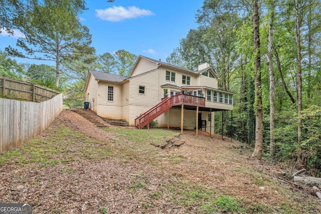 back of property featuring a wooden deck