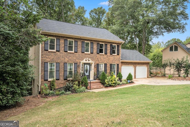 colonial home with a front yard and a garage