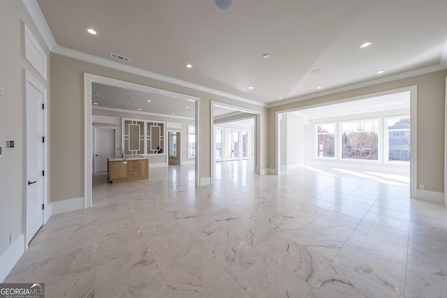 unfurnished living room with ornamental molding