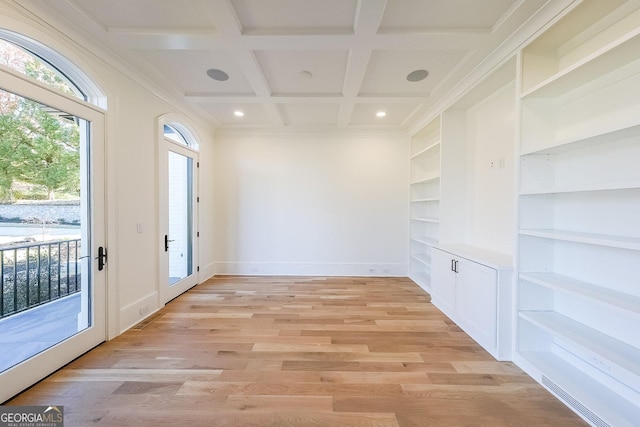 interior space featuring built in shelves, beamed ceiling, coffered ceiling, and light wood-type flooring