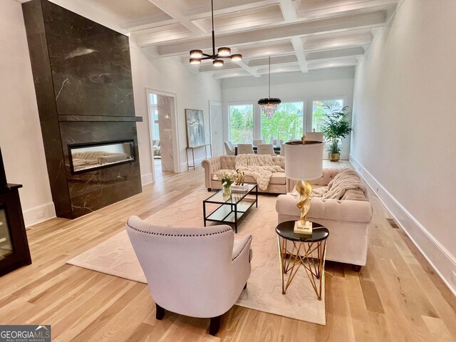 unfurnished living room featuring basketball court, coffered ceiling, beam ceiling, hardwood / wood-style flooring, and an inviting chandelier