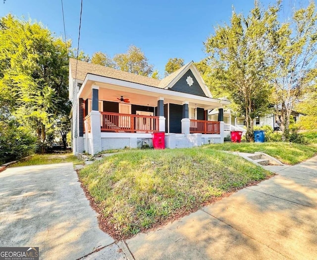 view of front of home with covered porch and a front yard