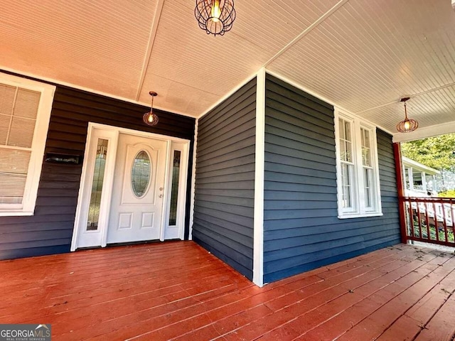 view of exterior entry with a porch