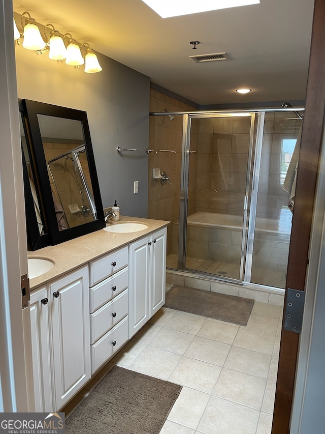 bathroom with walk in shower, tile patterned flooring, and vanity