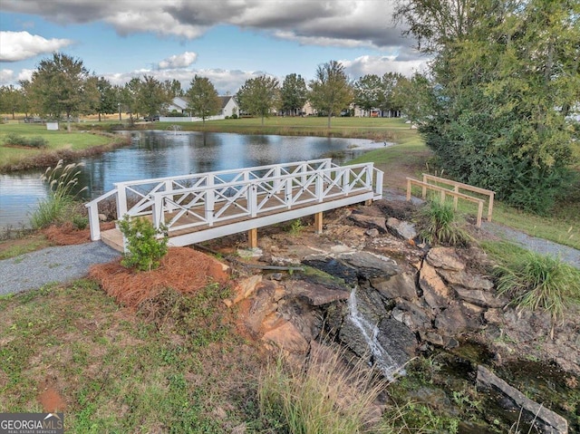 view of property's community featuring a water view and a yard