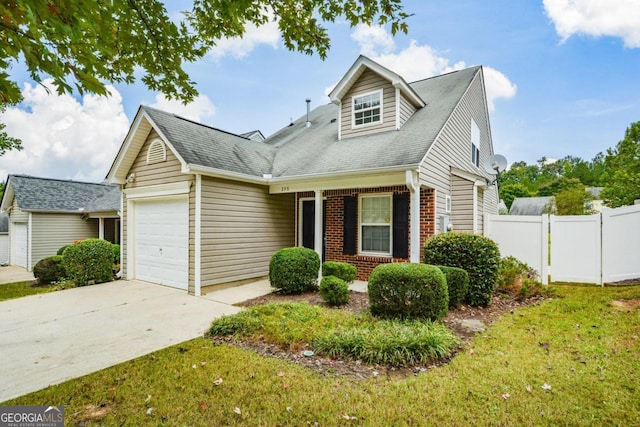 view of front of house featuring a garage and a front lawn