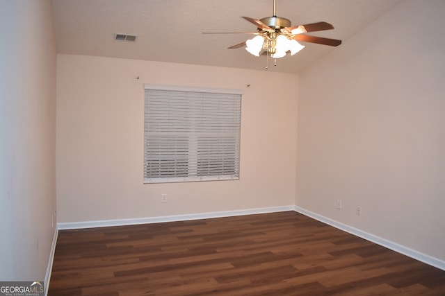 unfurnished room with ceiling fan, vaulted ceiling, and dark wood-type flooring