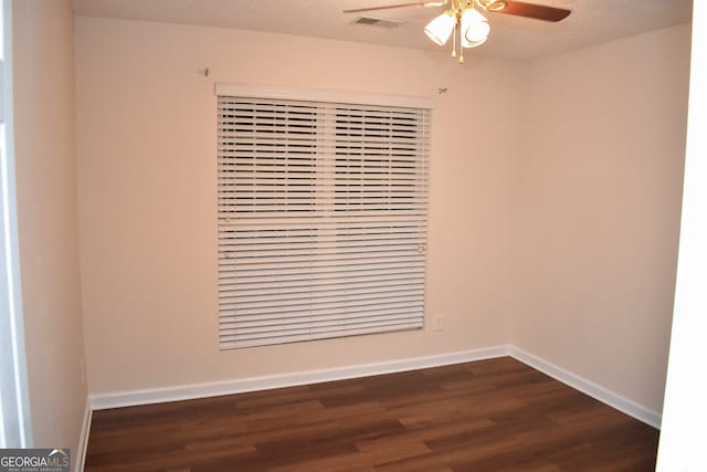 spare room featuring dark hardwood / wood-style floors, a textured ceiling, and ceiling fan