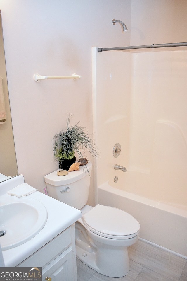 full bathroom with bathing tub / shower combination, vanity, and toilet