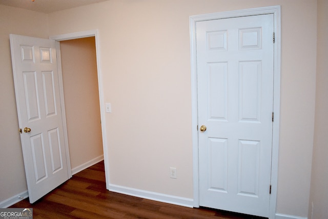 unfurnished bedroom with dark hardwood / wood-style flooring