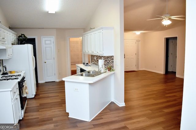 kitchen with white cabinets, sink, kitchen peninsula, white range with gas stovetop, and dark hardwood / wood-style floors