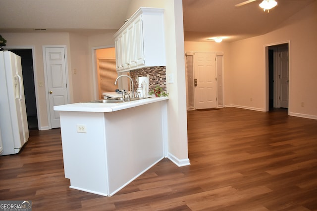 kitchen with white fridge with ice dispenser, white cabinets, dark hardwood / wood-style floors, and kitchen peninsula