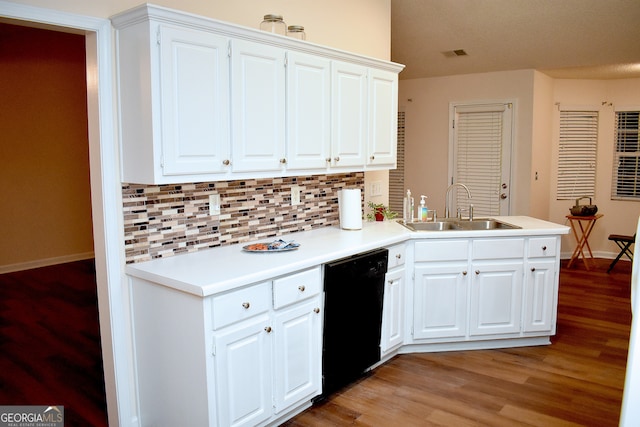 kitchen featuring tasteful backsplash, black dishwasher, light hardwood / wood-style flooring, sink, and white cabinetry