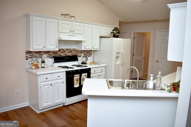 kitchen with white cabinets, sink, white appliances, dark hardwood / wood-style floors, and vaulted ceiling