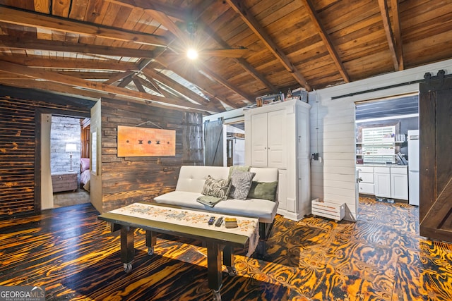 living area featuring a barn door, lofted ceiling with beams, wooden walls, and wood ceiling