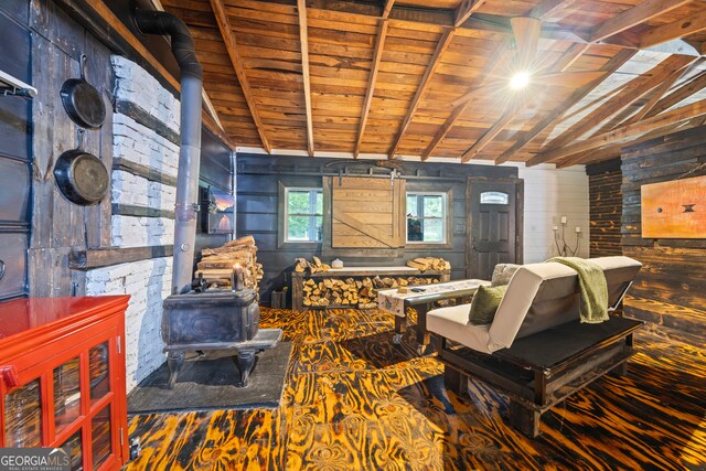 living room featuring wood walls, a wood stove, lofted ceiling with beams, hardwood / wood-style flooring, and wood ceiling