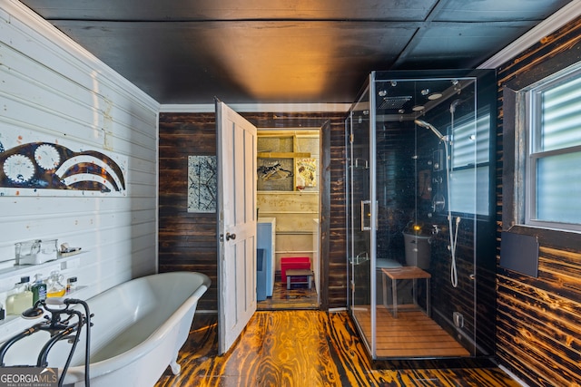 bathroom featuring wood-type flooring, a bathtub, and wooden walls