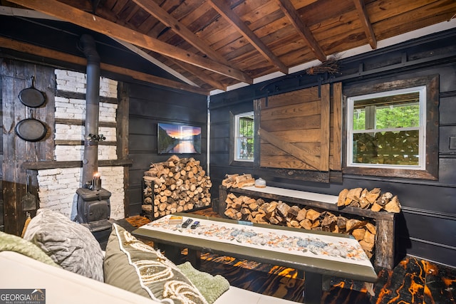 interior space featuring beamed ceiling, wooden ceiling, and wood walls