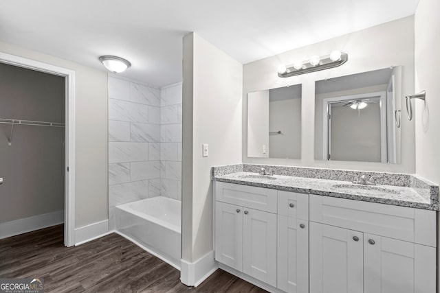 bathroom featuring wood-type flooring, ceiling fan, and vanity