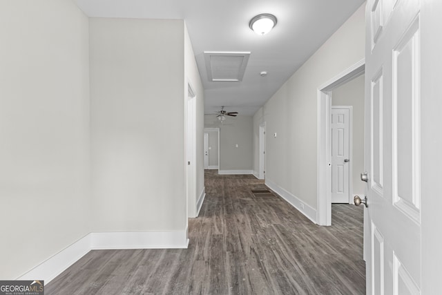 corridor with hardwood / wood-style flooring