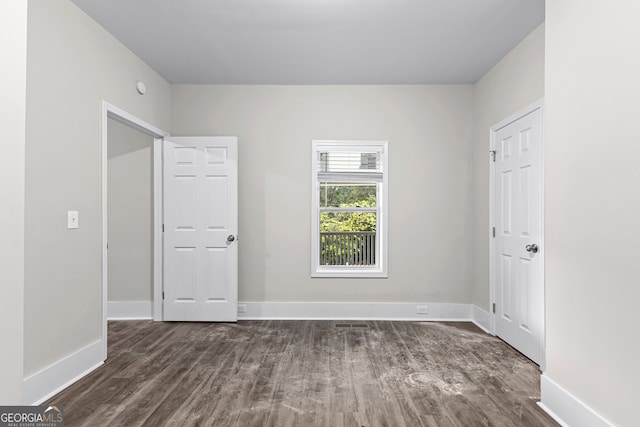 unfurnished room featuring dark hardwood / wood-style floors