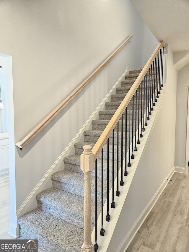 stairs with wood-type flooring