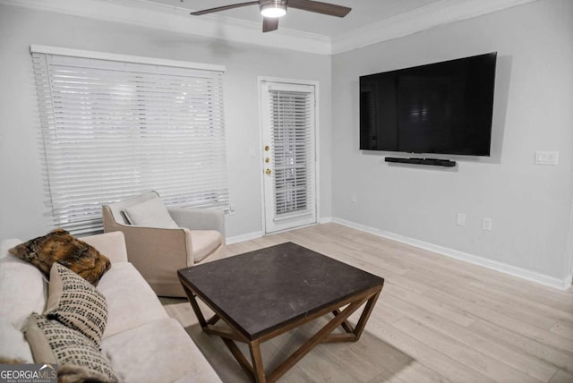 living room with crown molding, light hardwood / wood-style floors, and ceiling fan