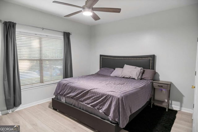 bedroom with light hardwood / wood-style floors and ceiling fan