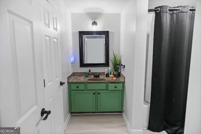 bathroom featuring a shower with shower curtain, vanity, and hardwood / wood-style flooring