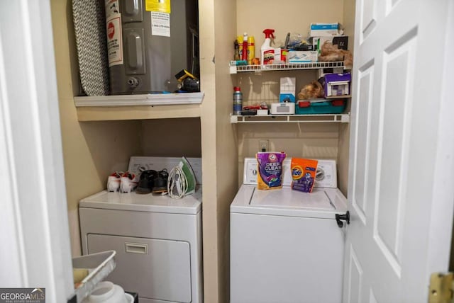 laundry room with electric water heater and washer and dryer