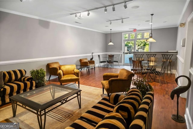 living room featuring light wood-type flooring, rail lighting, and ornamental molding