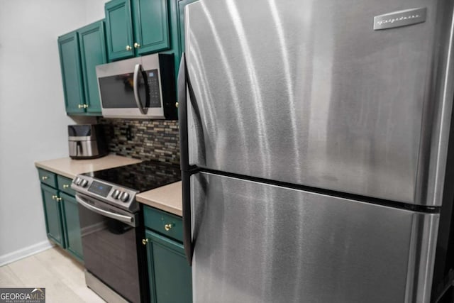 2700 Pine St NE Unit 2108, Atlanta, GA 30324 - kitchen with appliances with stainless steel finishes, green cabinets, tasteful backsplash, and light countertops