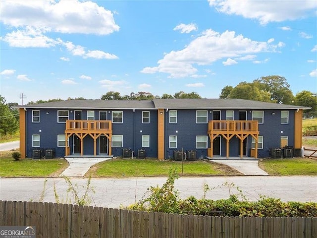 view of front of house with a balcony and central AC