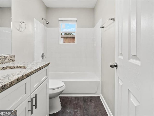 full bathroom featuring wood-type flooring, vanity, toilet, and tiled shower / bath combo