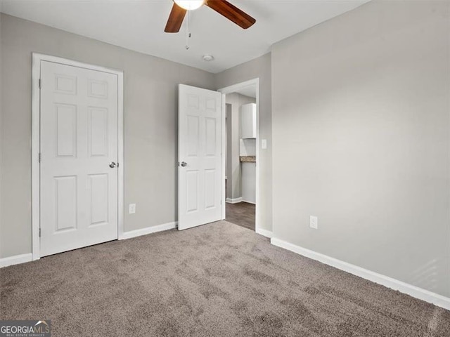 unfurnished bedroom with ceiling fan and carpet flooring