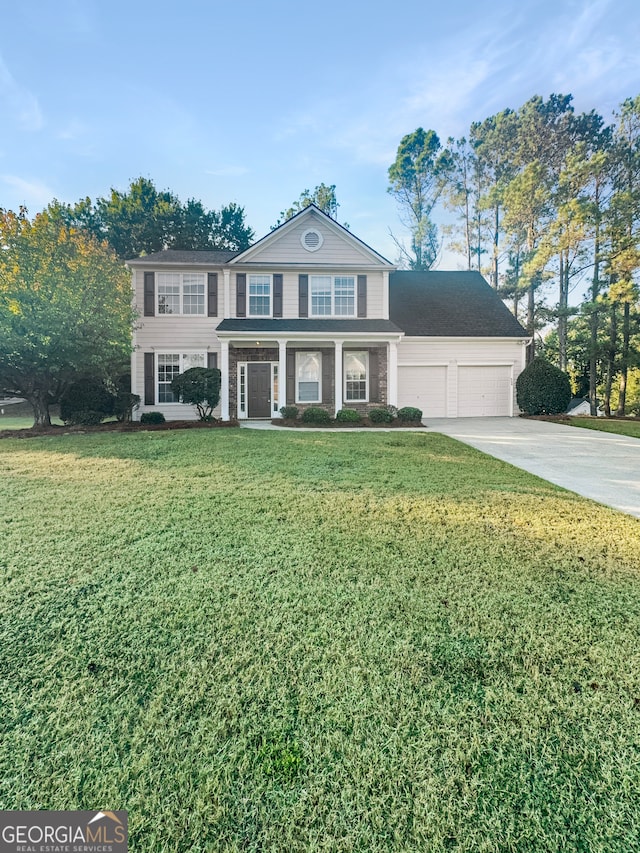 view of front of house featuring a front yard and a garage