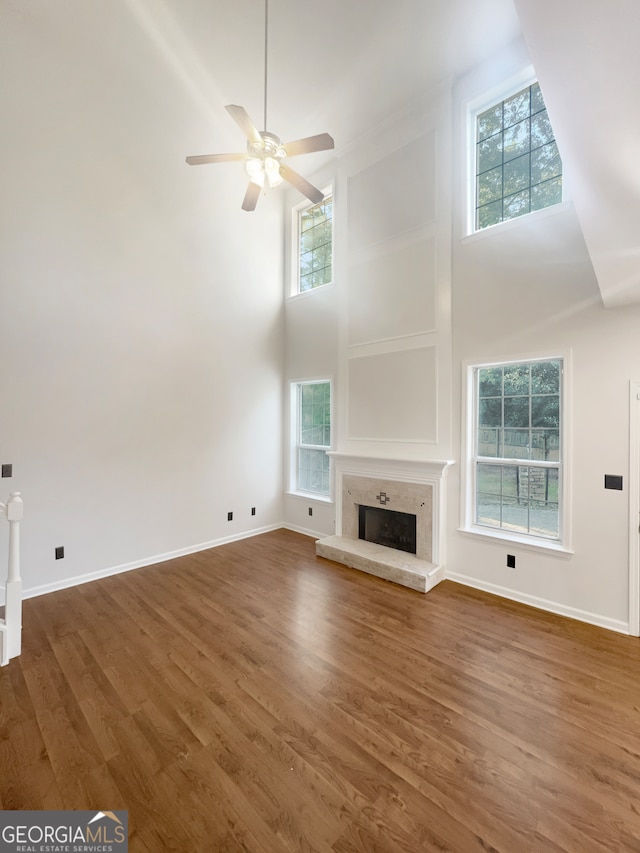 unfurnished living room with dark hardwood / wood-style flooring and plenty of natural light