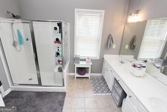 bathroom with tile patterned flooring, walk in shower, and vanity