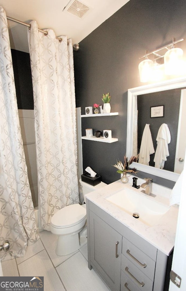 full bathroom with tile patterned flooring, vanity, toilet, and shower / bath combination with curtain