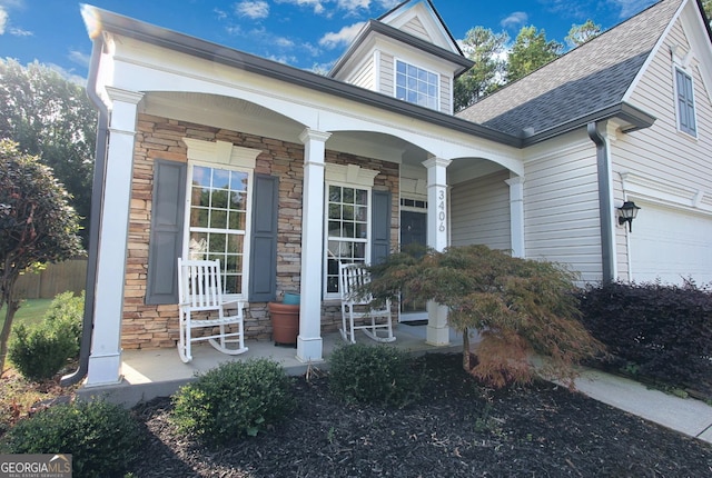 doorway to property with a porch and a garage