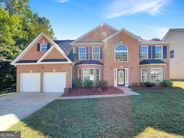 view of front of home featuring a front yard and a garage