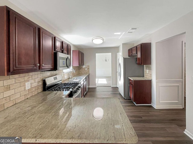 kitchen featuring dark hardwood / wood-style flooring, stainless steel appliances, tasteful backsplash, and sink