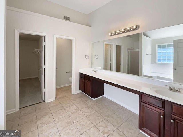 full bathroom featuring tile patterned floors, separate shower and tub, vanity, and toilet