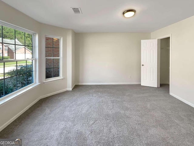 empty room with dark colored carpet