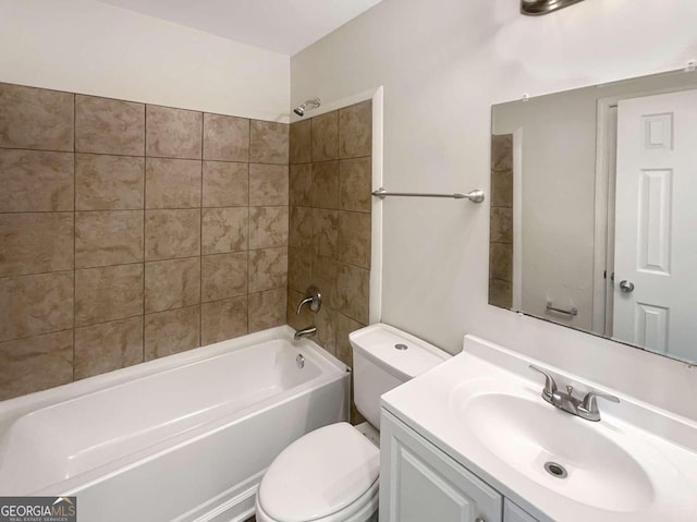 full bathroom featuring tiled shower / bath combo, vanity, and toilet