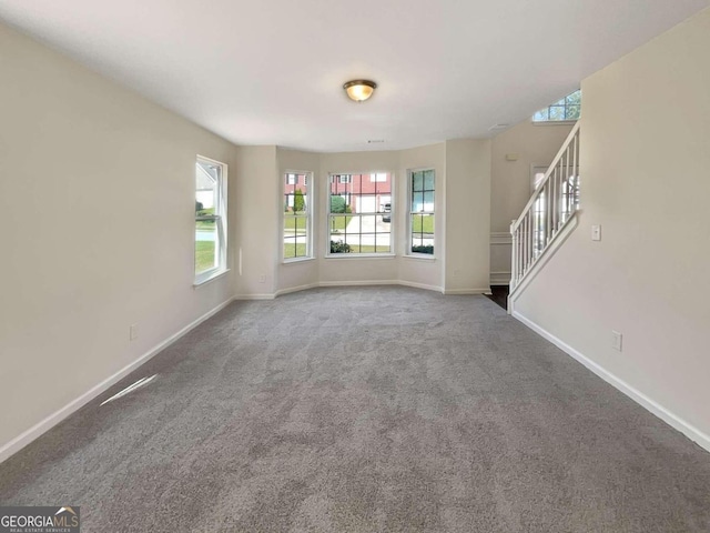 unfurnished living room featuring carpet flooring