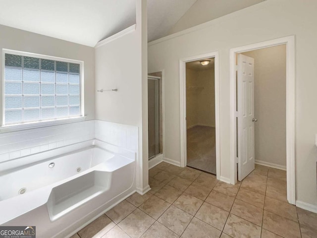 bathroom with vaulted ceiling, tile patterned floors, and separate shower and tub