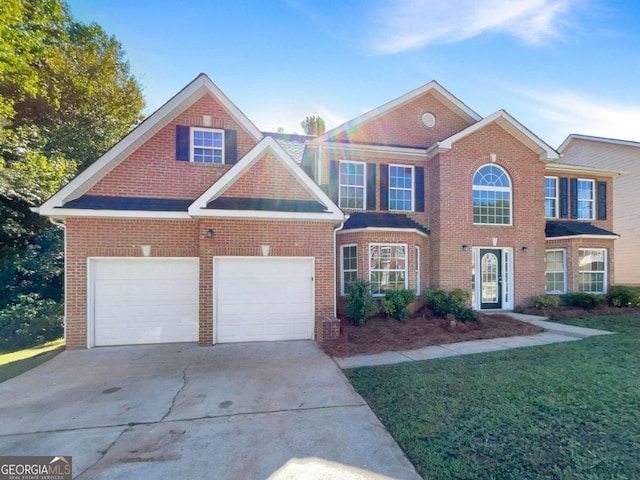 view of front of property featuring a garage and a front yard