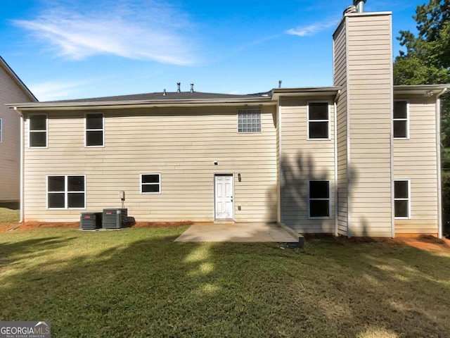 back of property with a yard, a patio, and central air condition unit