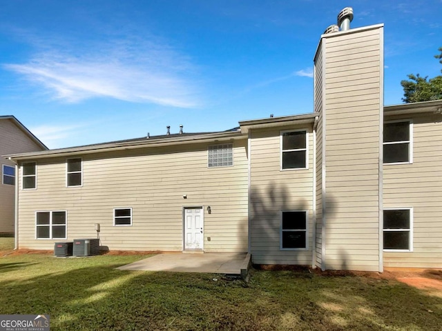 back of house with a lawn, central AC, and a patio area